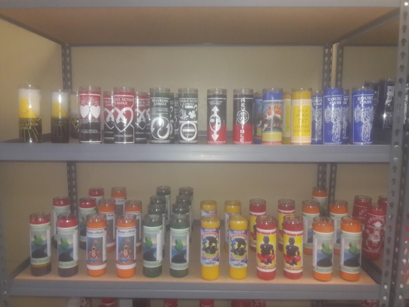 Shelves of seven-day candles at Treadway Botanica — reversible, road opener, and court case candles